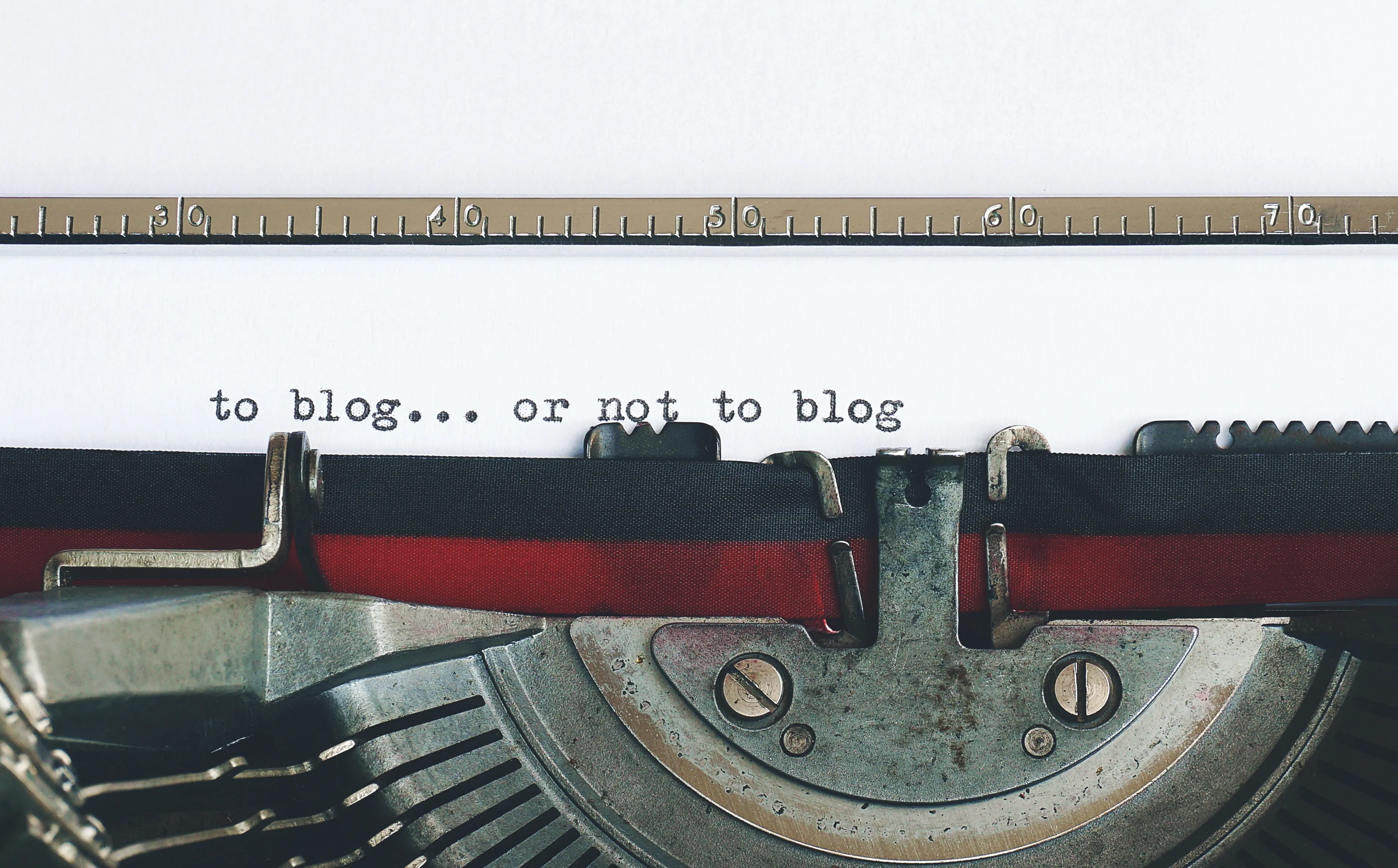 Typewriter with a sheet of paper, having typed the words: TO BLOG OR NOT TO BLOG